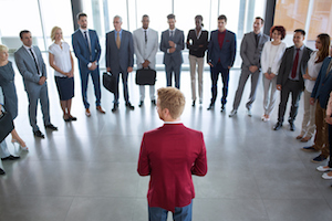 leader standing in front of his successful business team