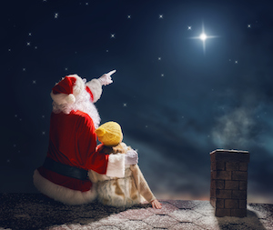 girl and Santa Claus sitting on the roof