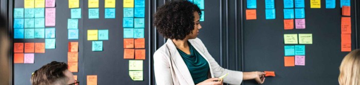 woman standing in front of sitting people