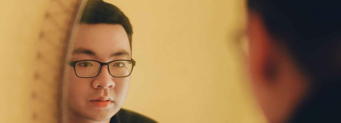 man looking at mirror