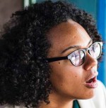 woman sitting on chair while using laptop computer