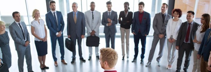 leader standing in front of his successful business team