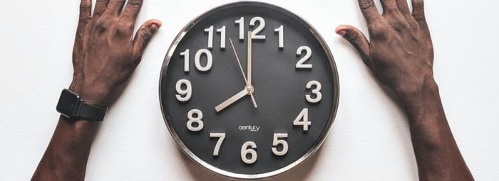 round silver colored wall clock