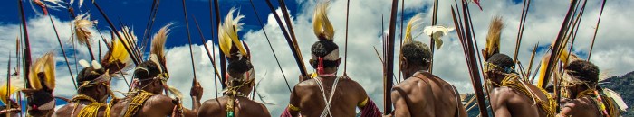 men wearing tribal costumes during day