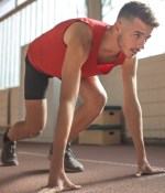 man in red tank top is about to run